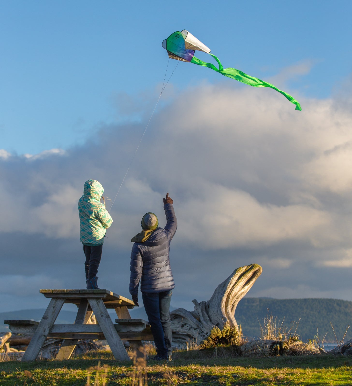 Parent and child flying Pocket Flyer at a park